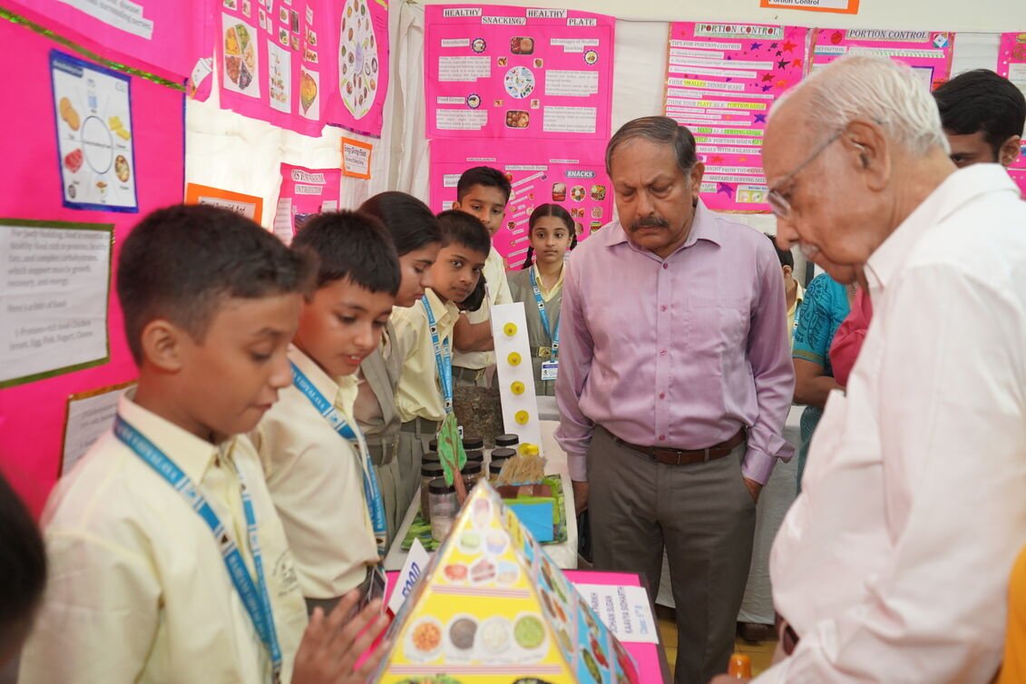 Teachers and judges evaluating student projects during the science fair